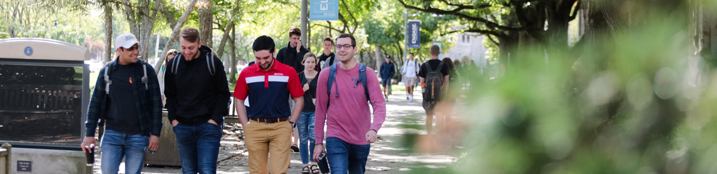 four male students walking by Atherton Union