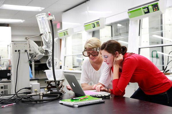 female students in chemistry lab looking at computer