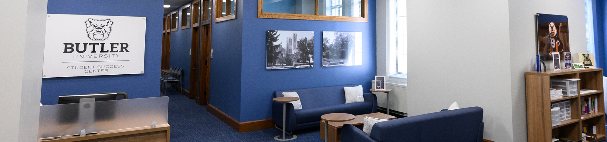 sign with Butler University Student Success Center, blue walls, blue chairs, photos on the walls