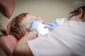 Dentist working on child's teeth.