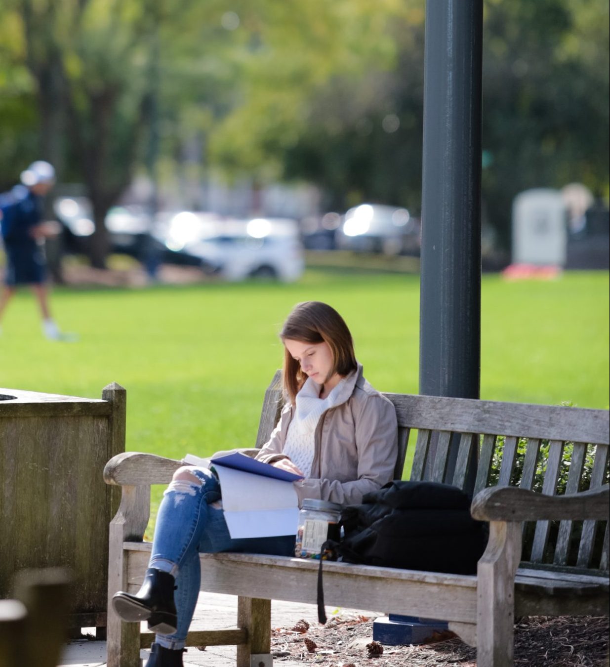 student studying on a bench outside
