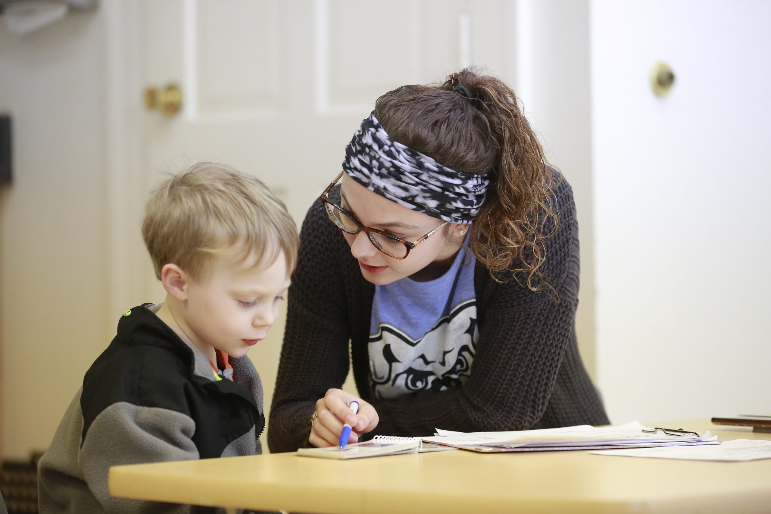 a student working with a preschooler