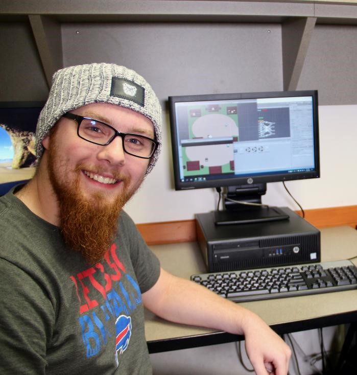 a student developing a game on a computer