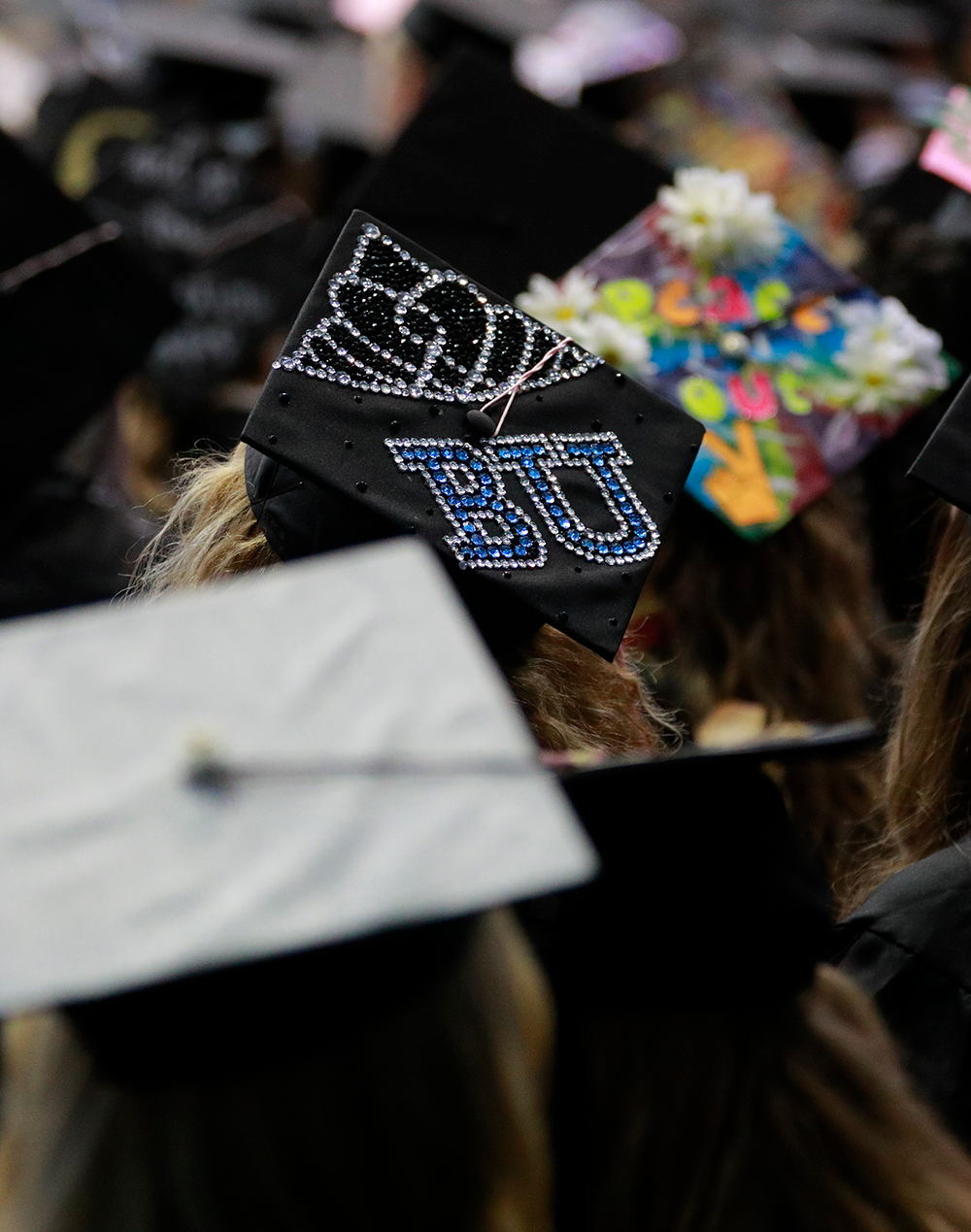 a decorated graduation cap with BU on it in sparkles