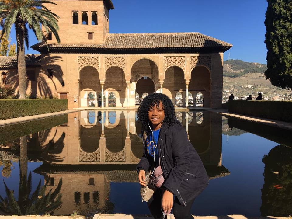 Student posing outside a castle