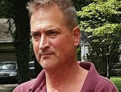 Grant Vecera male, gray hair, red shirt