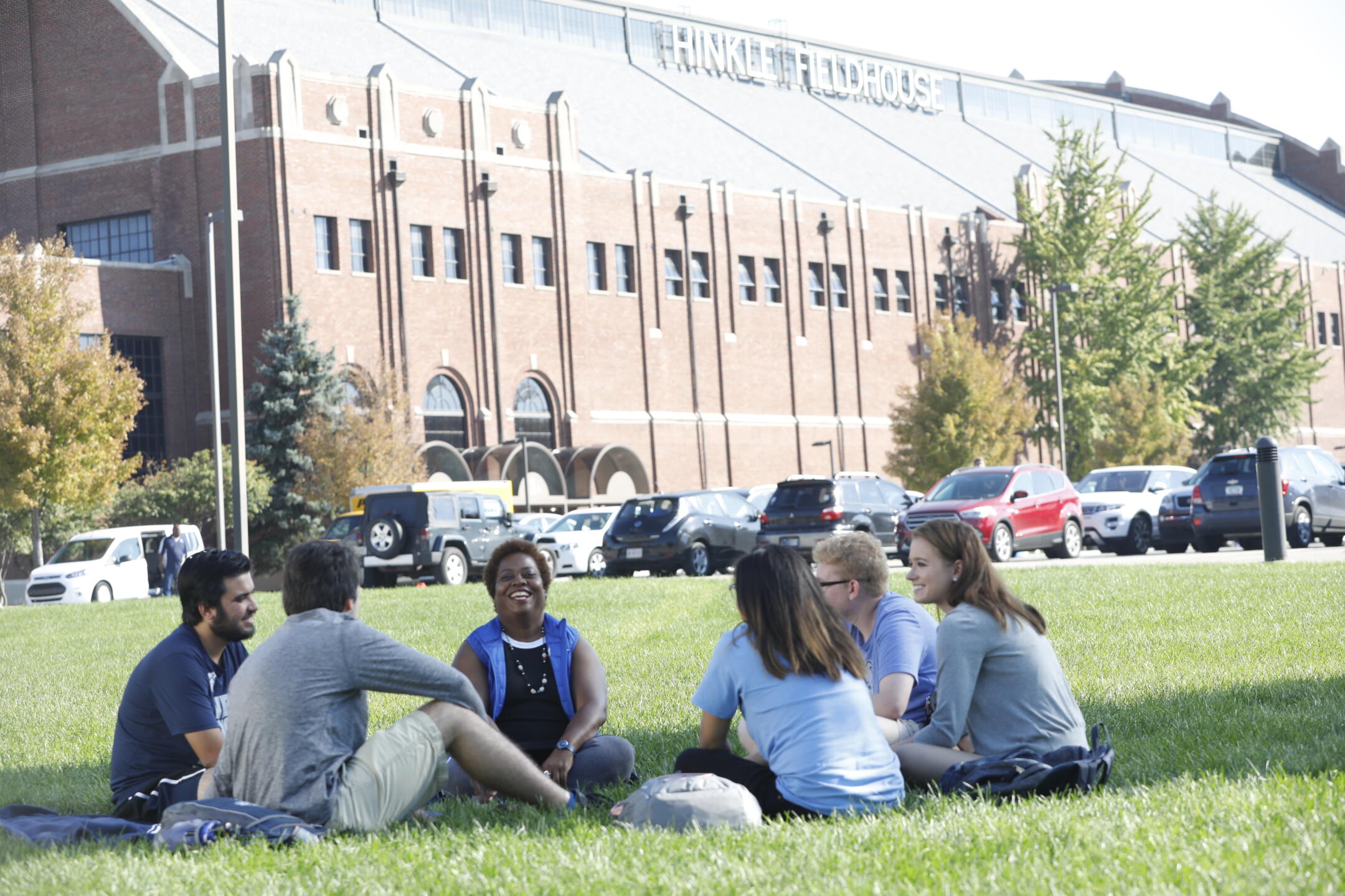 Students sit outside Hinkle Fieldhouse