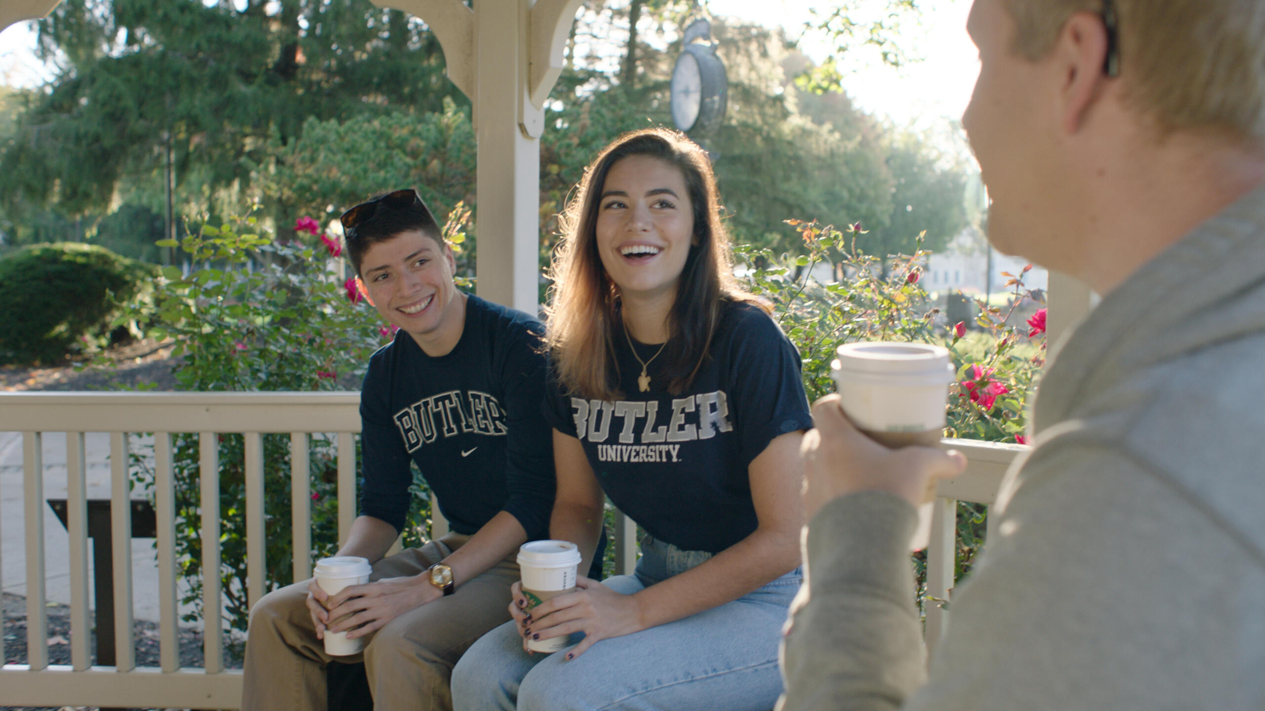 students drinking coffee in the gazebo