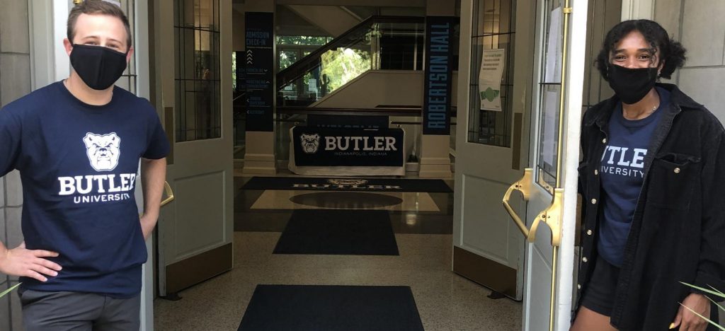 Butler students hold open the doors of Robertson Hall