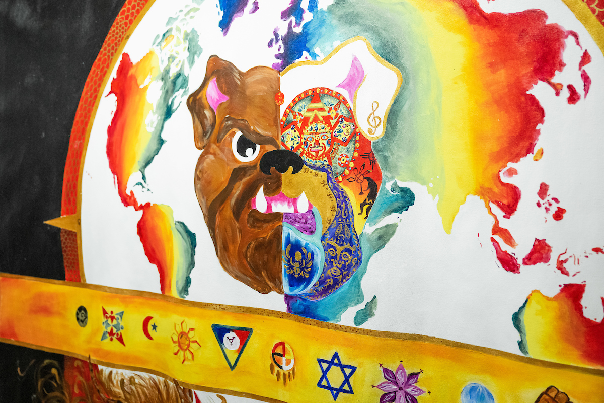 A painted mural of a bulldog against a map of the world