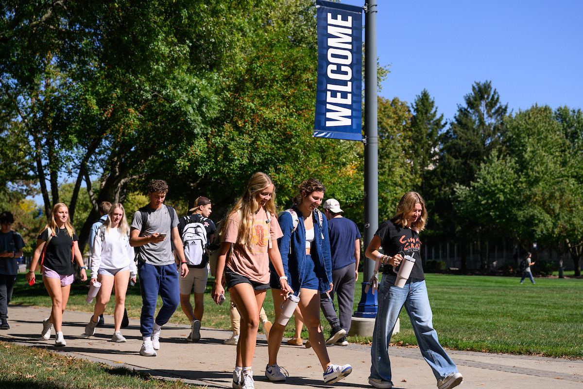 Students walking down a pathway on campus