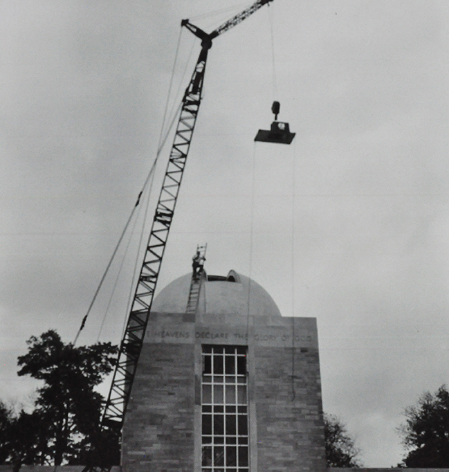 construction of Holcomb Observatory. a crane delivers a piece of roof