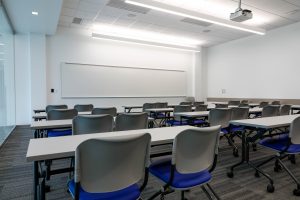 A classroom in the new Sciences complex; traditional desks are replaced with rolling tables and chairs that seat two side-by-side, encouraging collaboration