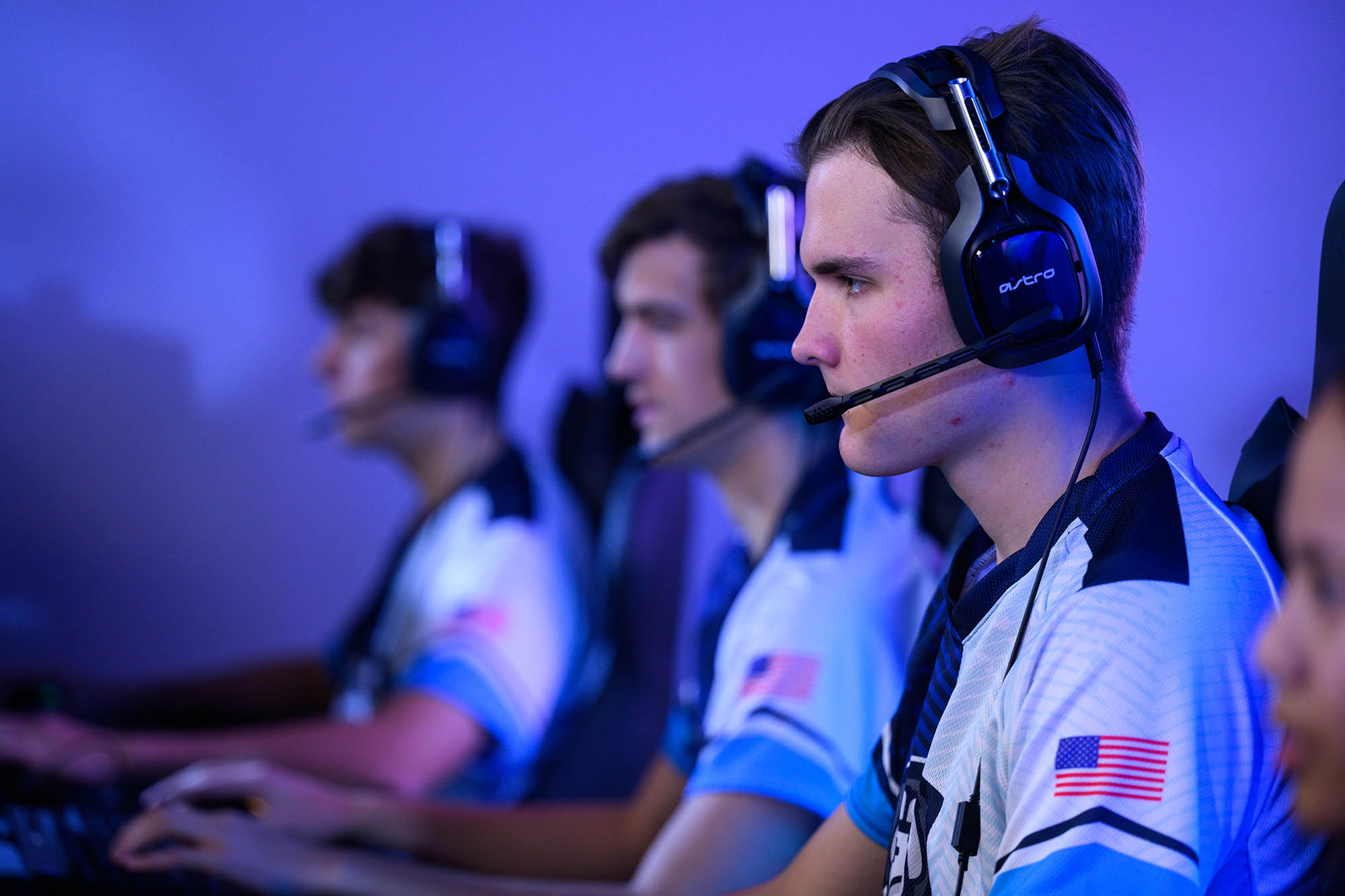 male members of the team wearing headsets and matching esports shirts