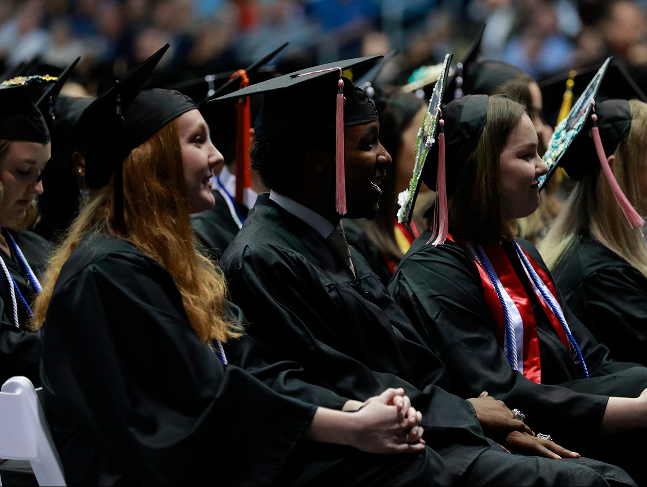 students wearing caps and gowns at commencement