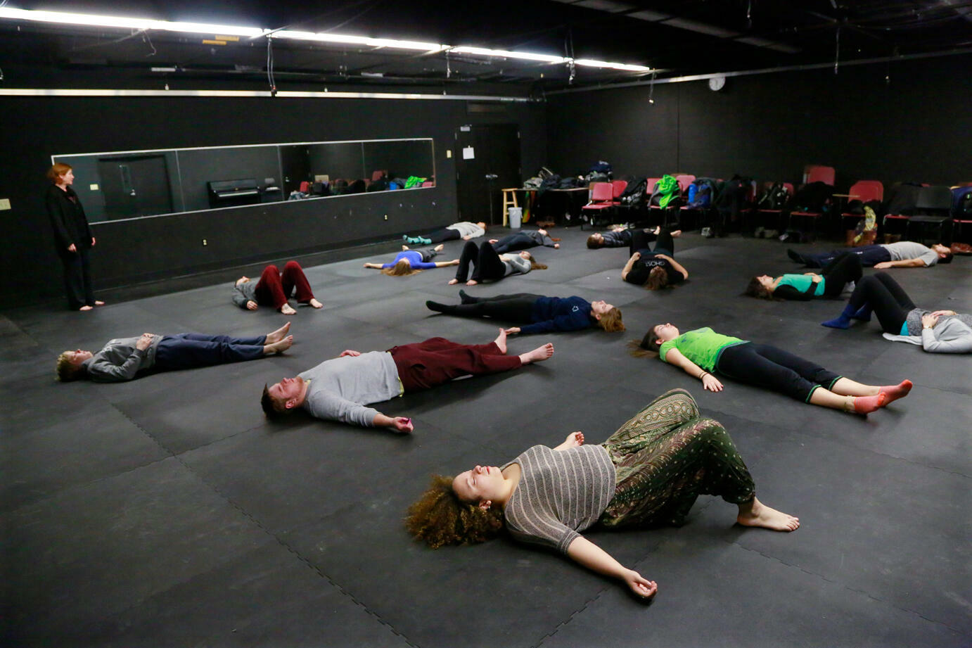 Actors stretching in black box theatre
