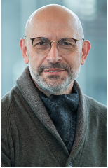 middle aged man with glasses and beard wearing a sweater