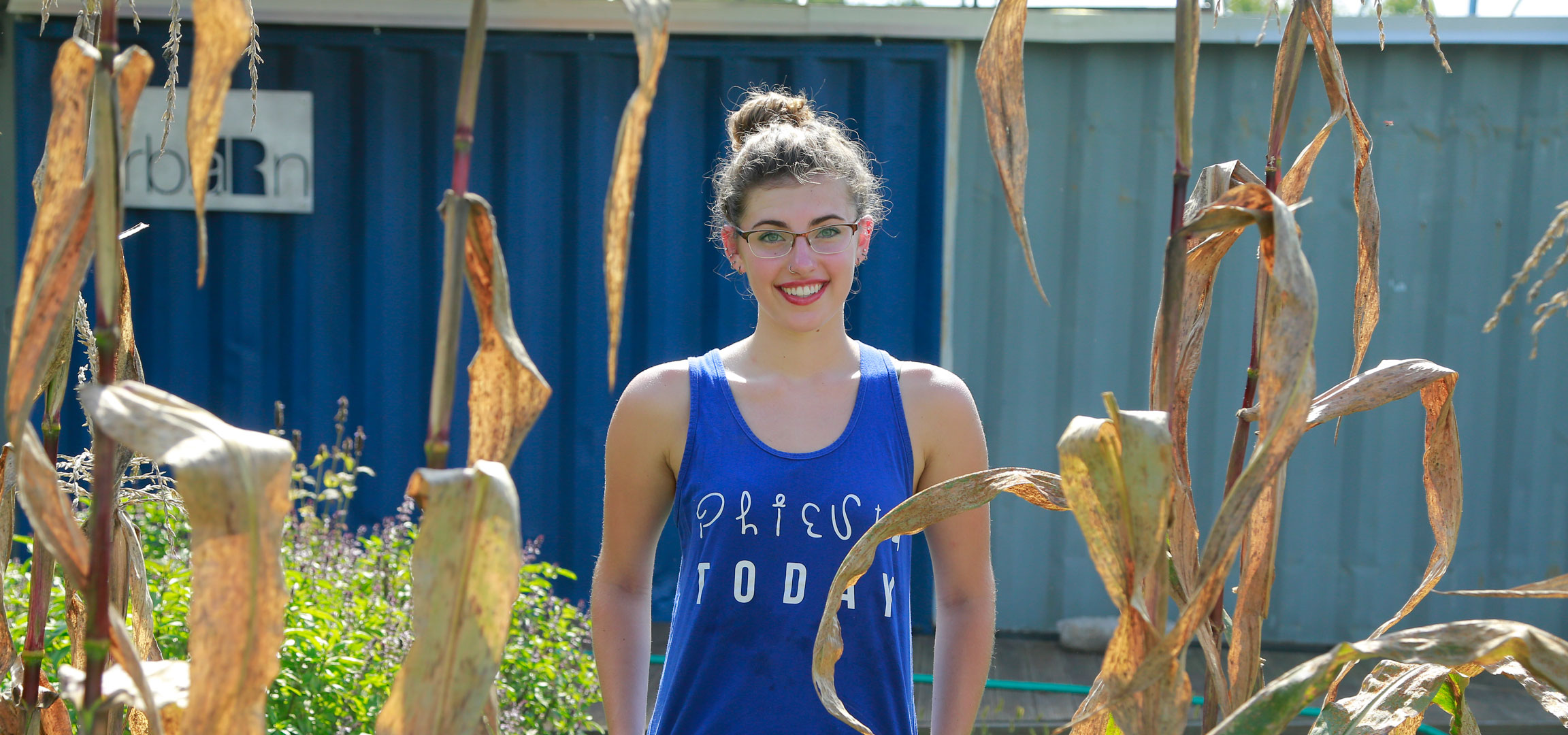 Student standing in a garden