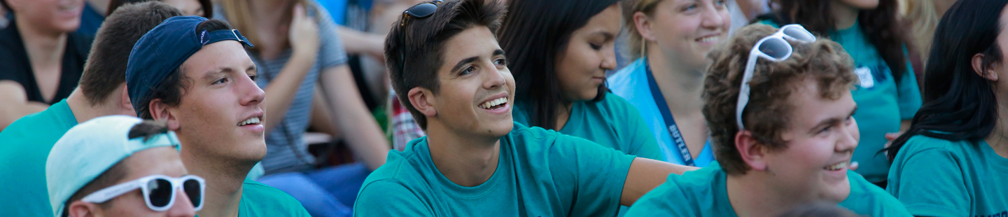 students wearing matching turquoise shirts