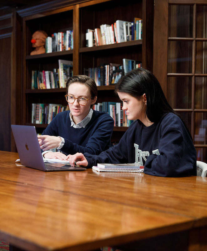 A student and faculty member review information together.