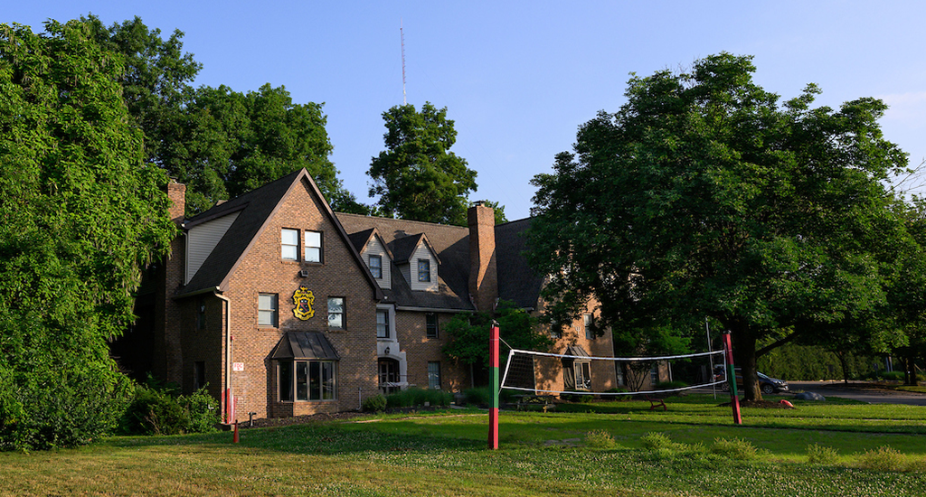 phi kappa psi house, red brick, pitched roof, volleyball net in front