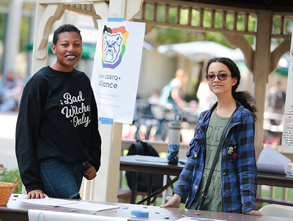 students at a table for the LGBTQ alliance on campus