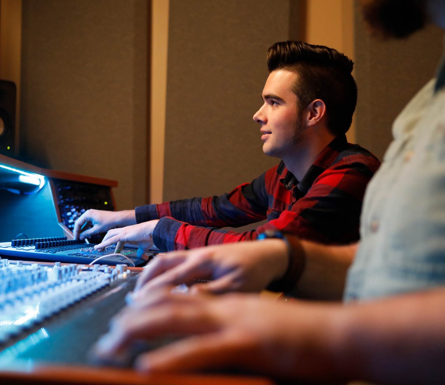 Student works at a mixing console