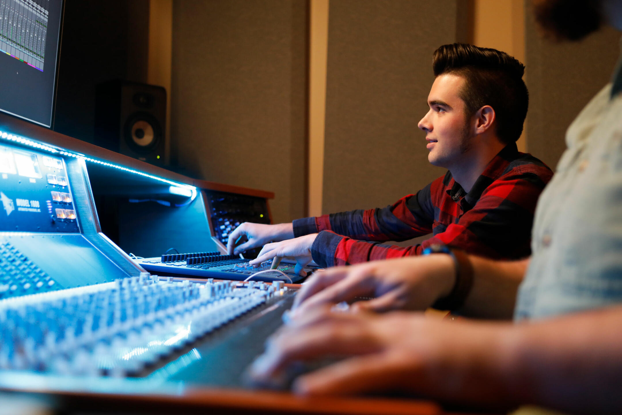Student working at audio mixing board