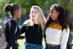 three female students smiling