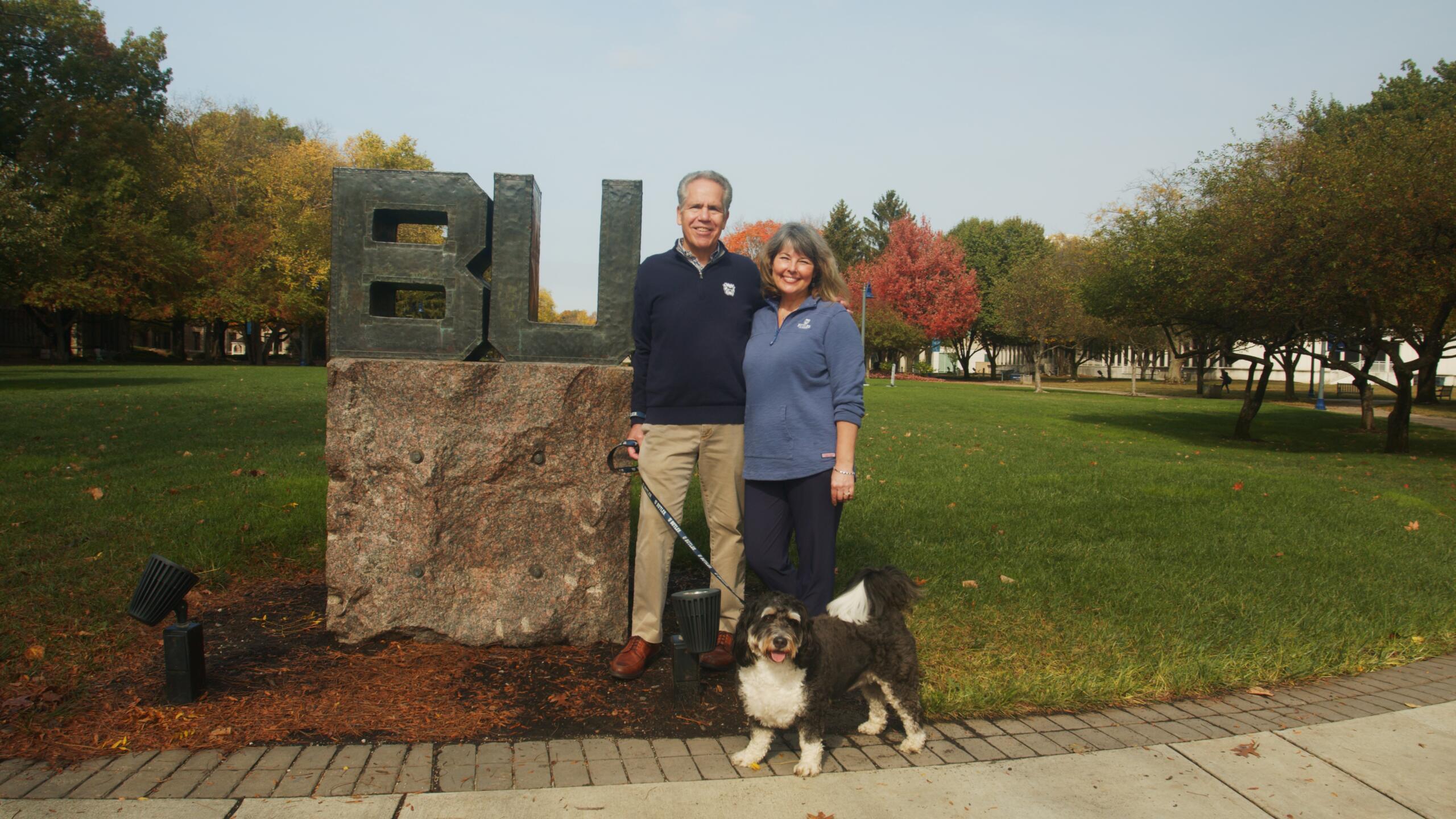 president danko and bethanie danko and black and white dog on a leash