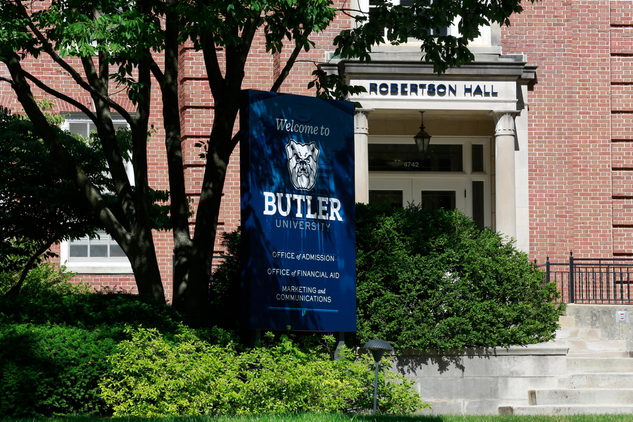 brick building with banner reading Welcome to Butler, and Robertson Hall written on the entrance