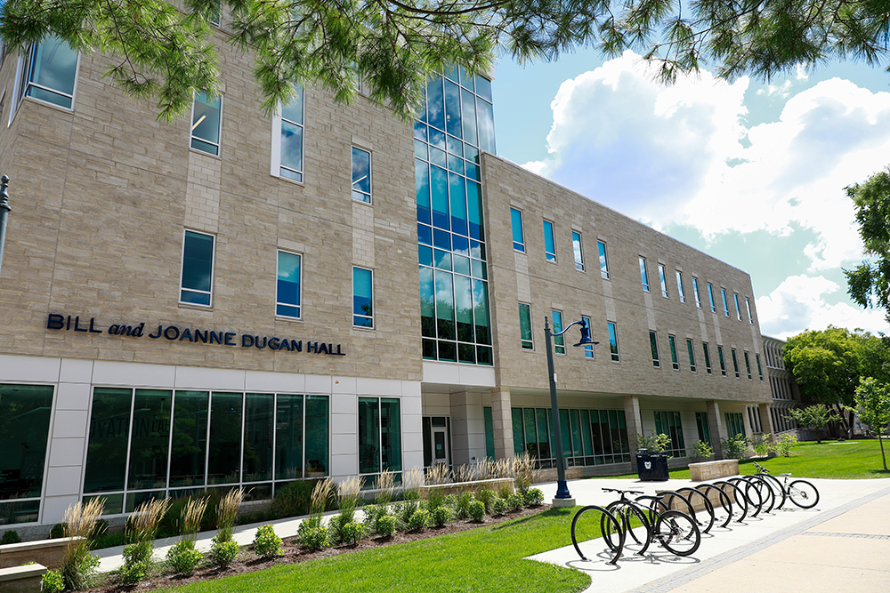 Front exterior of Dugan Hall, with bicycles parked outside