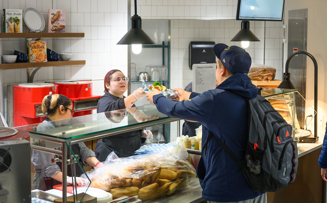 student getting food from buffet line